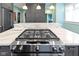 Modern kitchen features stainless steel appliances, a gas range, gray cabinets, and marble countertops at 3960 N Park Ave, Indianapolis, IN 46205