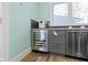 Kitchen with stainless steel wine cooler, gray cabinets, and stainless steel dishwasher at 3960 N Park Ave, Indianapolis, IN 46205