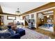 Open-concept living room with hardwood floors, vintage lighting and access to other rooms at 3960 N Park Ave, Indianapolis, IN 46205