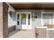 Inviting front porch featuring wood ceiling, brick columns, and classic architectural details at 3960 N Park Ave, Indianapolis, IN 46205