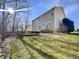 Spacious backyard with lush green grass, stone terrace, and a hot tub at 5099 Nicodemus Dr, Plainfield, IN 46168
