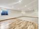 Finished basement area with wood laminate flooring, recessed lighting, and a window providing natural light at 5099 Nicodemus Dr, Plainfield, IN 46168