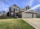 Beautiful brick and siding two-story home with an attached three-car garage at 5099 Nicodemus Dr, Plainfield, IN 46168