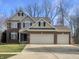 Charming two-story home featuring a three-car garage and a well-manicured lawn at 5099 Nicodemus Dr, Plainfield, IN 46168