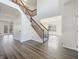 Bright, open foyer featuring hardwood floors, a staircase with wood railing, and an abundance of natural light at 5099 Nicodemus Dr, Plainfield, IN 46168
