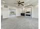 Bright, minimalist living room with a sleek ceiling fan and modern fireplace feature at 5099 Nicodemus Dr, Plainfield, IN 46168