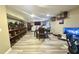 Finished basement with dining table, gray vinyl floors, and wall shelves with collectibles at 5941 Bonneville Way, Indianapolis, IN 46237