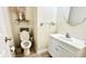 Stylish powder room with white vanity, decorative mirror, and charming decorative touches at 5941 Bonneville Way, Indianapolis, IN 46237