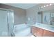 Neutral bathroom featuring a large soaking tub, separate shower, and double sink vanity at 5941 Bonneville Way, Indianapolis, IN 46237