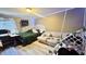 Bedroom with a bed, desk, couch and string lights along ceiling at 5941 Bonneville Way, Indianapolis, IN 46237