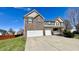 Beautiful brick home with a three-car garage and manicured lawn at 5941 Bonneville Way, Indianapolis, IN 46237