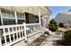 Inviting covered porch featuring a seating area with decorative plants and a charming welcome sign at 5941 Bonneville Way, Indianapolis, IN 46237