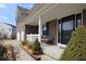 Comfortable covered front porch with an outdoor seating area and well-maintained landscaping at 5941 Bonneville Way, Indianapolis, IN 46237