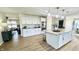 Bright kitchen featuring a large island with granite countertop, stainless appliances, and white cabinetry at 5941 Bonneville Way, Indianapolis, IN 46237