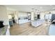 Bright kitchen featuring a large island with granite countertop, stainless appliances, and white cabinetry at 5941 Bonneville Way, Indianapolis, IN 46237