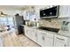 Modern kitchen with stainless steel appliances, granite countertops, and white cabinetry at 5941 Bonneville Way, Indianapolis, IN 46237
