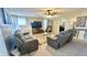 Spacious living room features an entertainment center, two reclining sofas, and a ceiling fan at 5941 Bonneville Way, Indianapolis, IN 46237