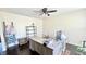 Bright home office featuring a spacious desk, ample storage, and a ceiling fan at 5941 Bonneville Way, Indianapolis, IN 46237