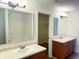 Bathroom featuring dual sinks, large mirrors, and a shower with a glass door at 6191 E Ayrshire Cir, Camby, IN 46113