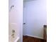 Bathroom with tiled shower, vanity with sink, and wood-look floors, well-lit with sconce lighting at 6191 E Ayrshire Cir, Camby, IN 46113