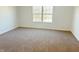 Bedroom featuring plush carpet, neutral walls, and natural light from a bright window at 6191 E Ayrshire Cir, Camby, IN 46113
