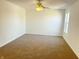 Bedroom featuring plush carpet, neutral walls, ceiling fan, and natural light from a bright window at 6191 E Ayrshire Cir, Camby, IN 46113