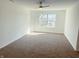Bedroom featuring plush carpet, neutral walls, ceiling fan, and natural light from a bright window at 6191 E Ayrshire Cir, Camby, IN 46113