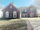 Beautiful home featuring brick, arched windows, shutters, and manicured lawn on a sunny day at 6191 E Ayrshire Cir, Camby, IN 46113