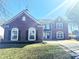 Inviting two-story brick home featuring arched windows, dark shutters, and a well-manicured front yard at 6191 E Ayrshire Cir, Camby, IN 46113