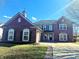 Front exterior of a beautiful brick home, with a charming yard and long driveway at 6191 E Ayrshire Cir, Camby, IN 46113