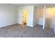 Hallway featuring carpet, neutral walls, and an open doorway leading to the tiled shower at 6191 E Ayrshire Cir, Camby, IN 46113