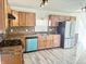 Bright kitchen featuring wood cabinetry, stainless steel appliances, and lovely backsplash at 6191 E Ayrshire Cir, Camby, IN 46113