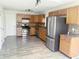 Modern kitchen featuring stainless steel appliances, wooden cabinets, and updated countertops at 6191 E Ayrshire Cir, Camby, IN 46113