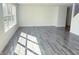 Open living room featuring large windows for natural light and modern flooring at 6191 E Ayrshire Cir, Camby, IN 46113