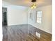 Bright living room featuring a modern chandelier, new grey flooring, and a front door with side lights at 6191 E Ayrshire Cir, Camby, IN 46113