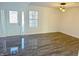 Bright living room featuring a modern chandelier, new grey flooring, and a front door with side lights at 6191 E Ayrshire Cir, Camby, IN 46113