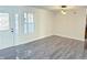 Bright living room featuring a modern chandelier, new grey flooring, and a front door with side lights at 6191 E Ayrshire Cir, Camby, IN 46113