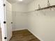 Walk-in closet with shelving and laminate wood flooring with natural light at 6191 E Ayrshire Cir, Camby, IN 46113