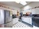 Bright kitchen featuring stainless steel appliances and black and white checkered flooring at 628 Southridge Ct, Westfield, IN 46074