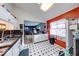 Open kitchen with stainless steel appliances and black and white checkered flooring leading to the living area at 628 Southridge Ct, Westfield, IN 46074