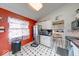 Well-lit kitchen featuring stainless steel appliances, colorful decor, and black and white checkered flooring at 628 Southridge Ct, Westfield, IN 46074