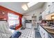Bright kitchen featuring stainless steel appliances, black countertops, and black and white checkered flooring at 628 Southridge Ct, Westfield, IN 46074