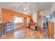 Bright living room featuring laminate floors, an orange accent wall, and vaulted ceilings at 628 Southridge Ct, Westfield, IN 46074
