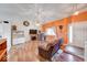 Bright living room featuring laminate floors, an electric fireplace, vaulted ceilings, and an orange accent wall at 628 Southridge Ct, Westfield, IN 46074