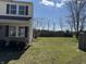 Partially fenced backyard with an air conditioning unit and lush lawn, offering privacy and comfort at 6417 E Clarks Hill Ct, Camby, IN 46113