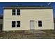 Back of a two-story home with vinyl siding, an access door, and an unfinished patio area at 6417 E Clarks Hill Ct, Camby, IN 46113