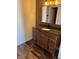 Bathroom vanity with granite countertop, framed mirror, and decorative wood-style accent wall at 6417 E Clarks Hill Ct, Camby, IN 46113