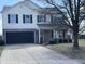 Two-story home with a brick and vinyl exterior and a two-car garage and a well manicured lawn at 6417 E Clarks Hill Ct, Camby, IN 46113