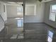 Open-concept living room with gray wood floors, white walls and ceilings, and a ceiling fan at 6417 E Clarks Hill Ct, Camby, IN 46113