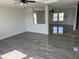 Open-concept living room with gray wood floors, white walls and ceilings, and a ceiling fan at 6417 E Clarks Hill Ct, Camby, IN 46113